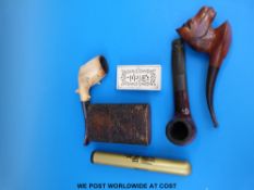 A collection of pipes including hallmarked silver mounted Meerschaum treen box and a bone