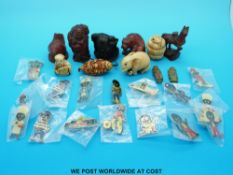 A collection of netsukes including carved wooden examples and some golly badges