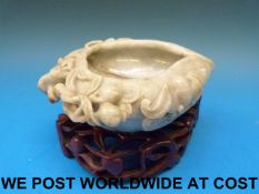 A Chinese jadeite brush washer in the shape of a peach carved in relief with bats and clouds,