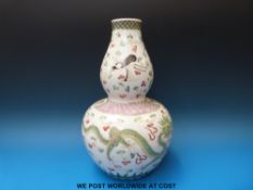 A 19thC Chinese double gourd vase with dragon chasing flaming pearl decoration,
