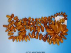 A butterscotch amber necklace of 97 irregular shaped beads (60g)