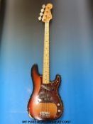 A late 1960's Fender Precision bass guitar in sunburst finish, made in the USA,