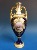 A Coalport twin handled pedestal vase with decoration of a lake and mountain scenes (height 20cm)