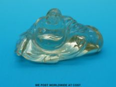 A carved citrine figure of a seated Buddha (8 x 3.5 x 3.