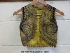 An Indian waistcoat with scrolling metallic gilt threadwork