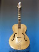 An anonymous acoustic cello guitar with six steel strings