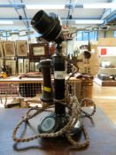 A vintage candlestick telephone with bakelite fittings,