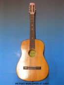 A six-string acoustic guitar by Boosey & Hawkes