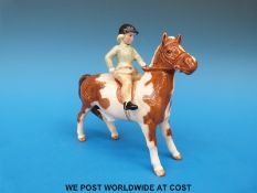 A Beswick girl on a skewbald pony
