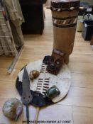 A collection of African artefacts including a shield, drum,