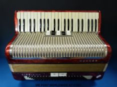 A Hohner Carena IIIM 120 bass piano accordion with five treble and two bass couplers in red