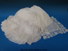 A handmade lace handkerchief together with a lace skirt