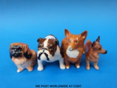 Two small Beswick and two small Doulton dogs,