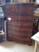 A bow fronted reproduction chest of drawers by Cameo.