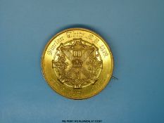 A yellow metal medallion engraved 'Sinclair White MD 1879 First Honour Class' with crest to verso