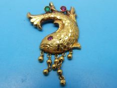 A gold pendant in the form of a fish,