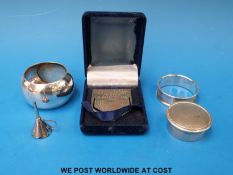 Two hallmarked silver napkin rings, silver pill box,