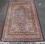 A blue ground rug with floral border (288 x 185cm)
