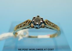 A 9ct gold ring set with a round brilliant cut diamond with diamond encrusted shoulders (size N)