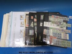 A quantity of GB and Commonwealth stamps on loose album pages and Hagner sheets George VI - QEII