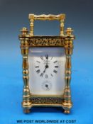 A Rapport London miniature gilt cased carriage clock in case with alarm function, height 10 cm.