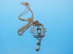 An Edwardian pendant set with two opals and seed pearls