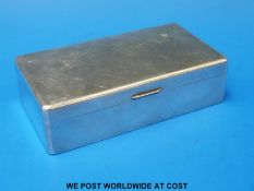 A hallmarked silver cigarette box, length 16.