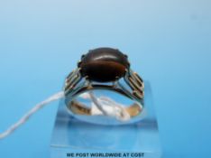 A 9ct gold ring set with an oval tigers eye cabochon (size N)