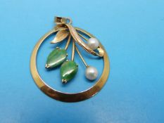 A yellow metal pendant marked 9ct gold set with two pear-shaped jadeite cabochons and two pearls