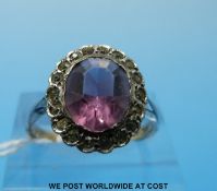 A yellow metal ring marked 9ct gold set with pink paste stone surrounded by clear paste stones