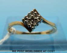 A 9ct gold ring set with nine diamonds in a square setting (size N)