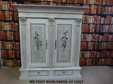 A painted and distressed Italian style cupboard with cupboard to top flanked by colums and two