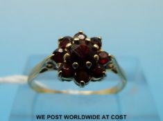 A 9ct gold ring set with a cluster of garnets (size L)