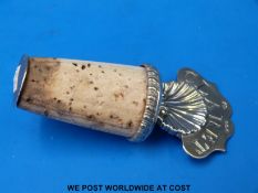 A Georgian hallmarked silver bottle stopper with shell below 