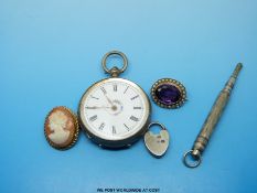 A white metal ladies fob watch marked 800, a silver brooch set with an amethyst, a cameo brooch,
