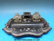 A mother-of-pearl inlaid papier mache inkstand (width 27cm)