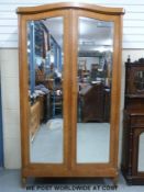 A 19thC French kingwood wardrobe or armoire with bevelled mirrors to each door,