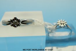 Two 9ct white gold rings set with diamonds in star shaped settings