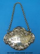 A William IV hallmarked silver Sherry bottle label with embossed border of grapes and a mythical