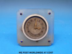 A small bedroom style clock marked 'The Goldsmiths and Silversmiths Co.