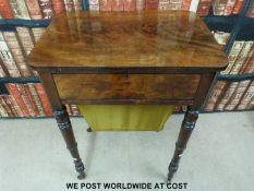 A 19thC flame mahogany work table with hinged lid and pull out tray below,