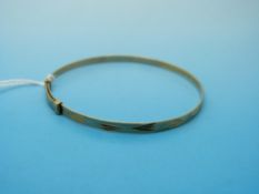 A 9ct gold extending christening bangle