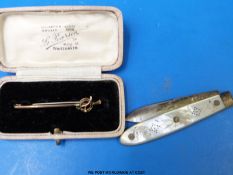 A 9ct gold brooch set with a green stone together with a hallmarked silver fruit knife with mother