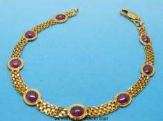 A 9ct gold bracelet set with eight rubies