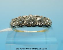 An 18ct gold ring set with five diamonds, the centre stone measuring approximately 0.