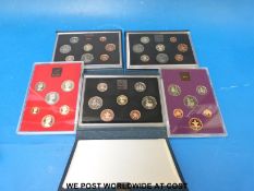 Three proof UK coin sets for 1983, 84 and 85 in deluxe cases,