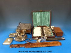 A silver plated and oak butter container, plated egg set,