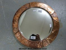 An early 20thC Arts & Crafts style beaten copper circular mirror (Diameter 39cm)