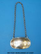 A Georgian hallmarked silver Madeira bottle label marked with Georgian duty mark,