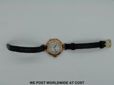 A 9ct gold ladies wristwatch with Arabic numerals, subsidiary seconds dial and blue hands,